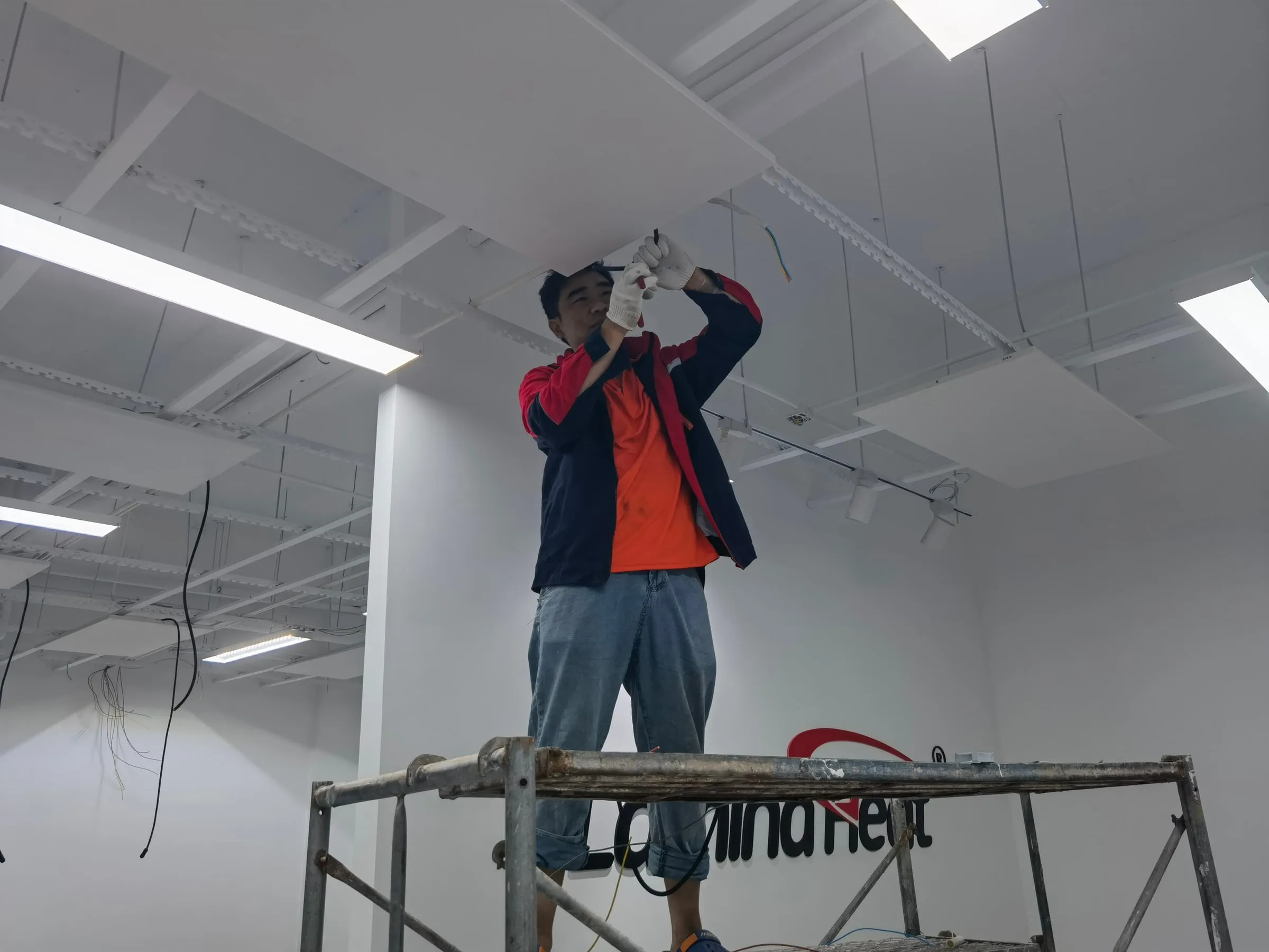 An installation crew laying out heating elements across an office floor