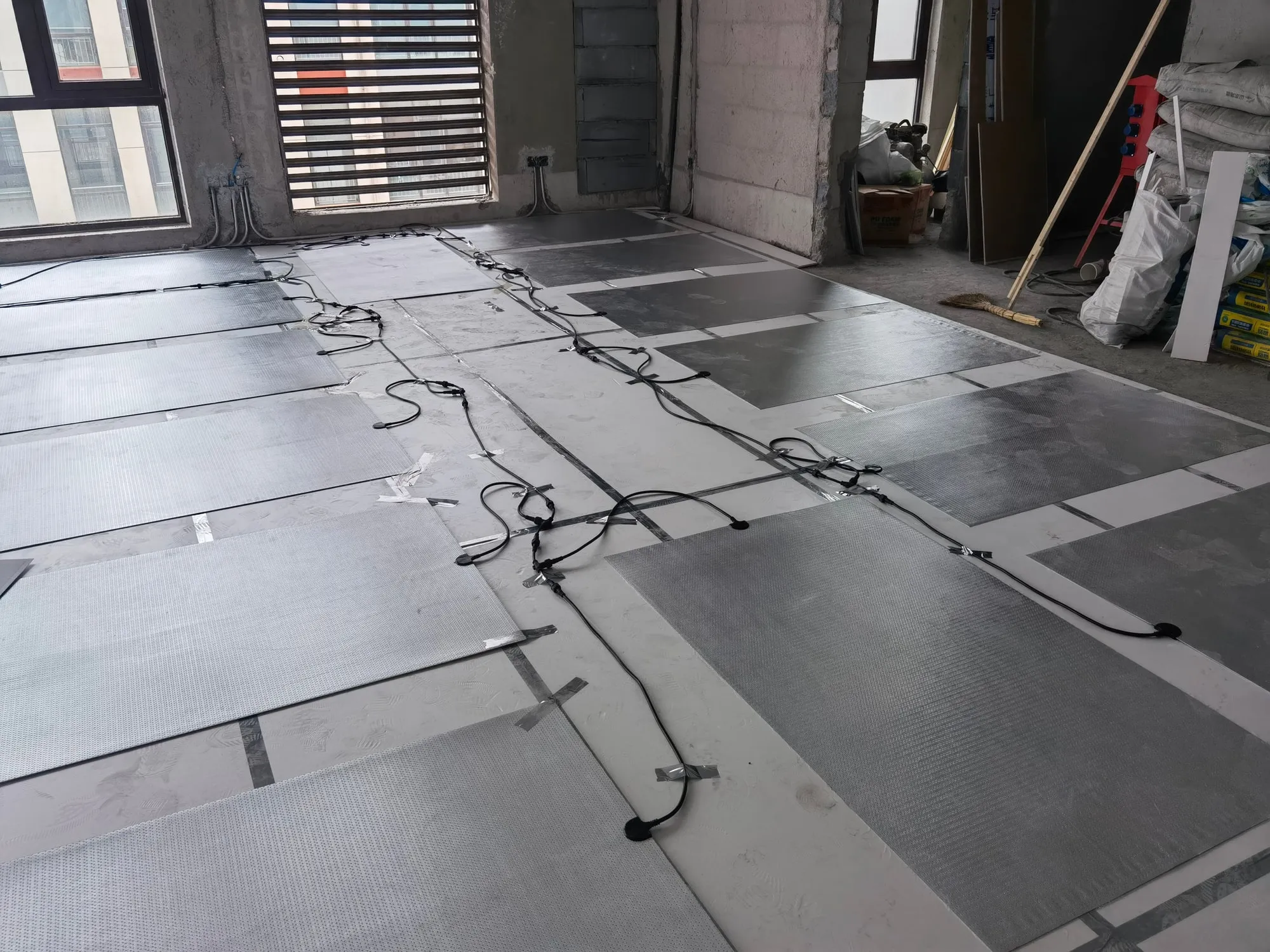 SafeTech EGS heaters laid out and cabled across an office floor
