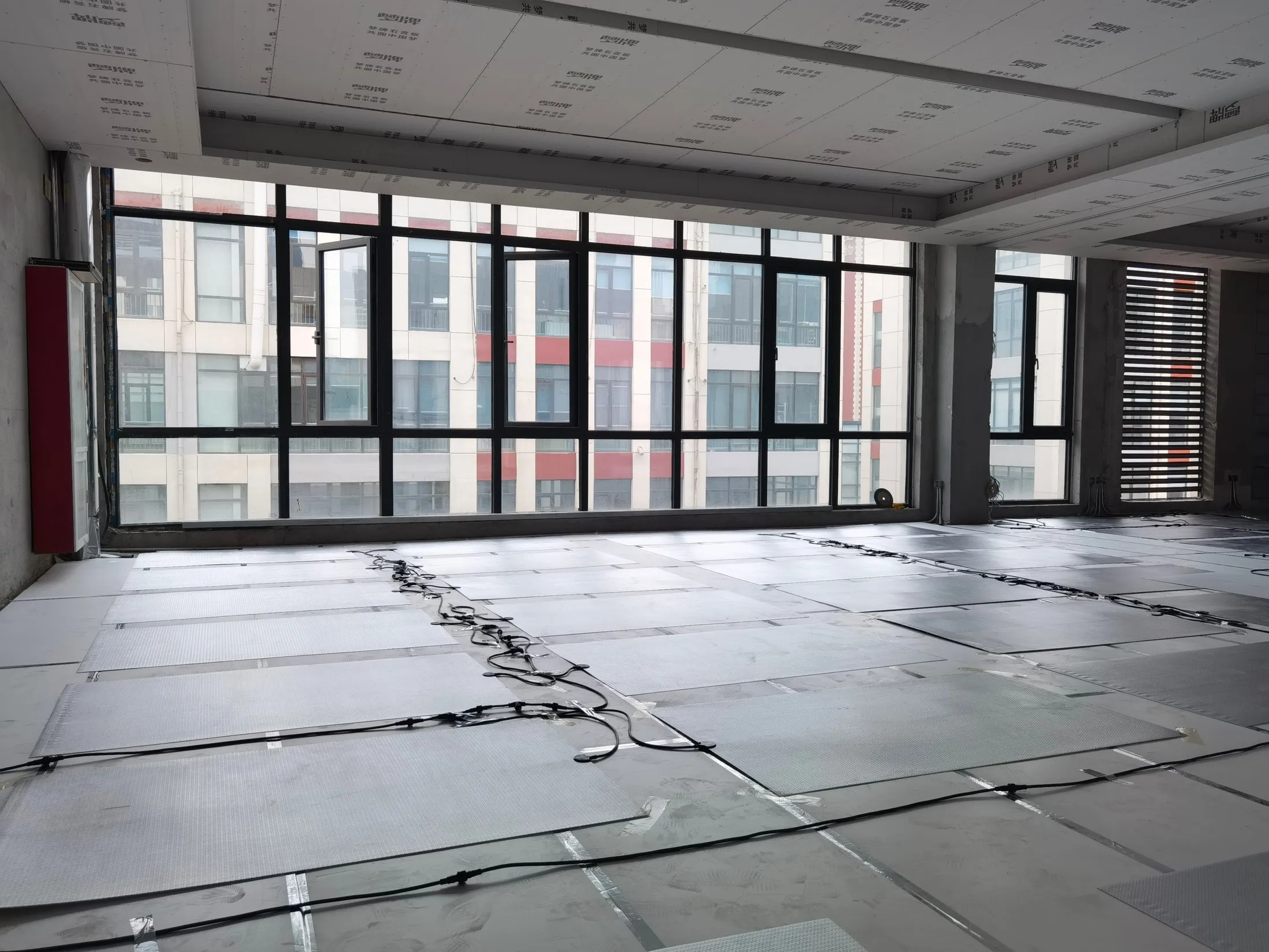 SafeTech EGS heaters laid out across an office floor with their cabling run between them