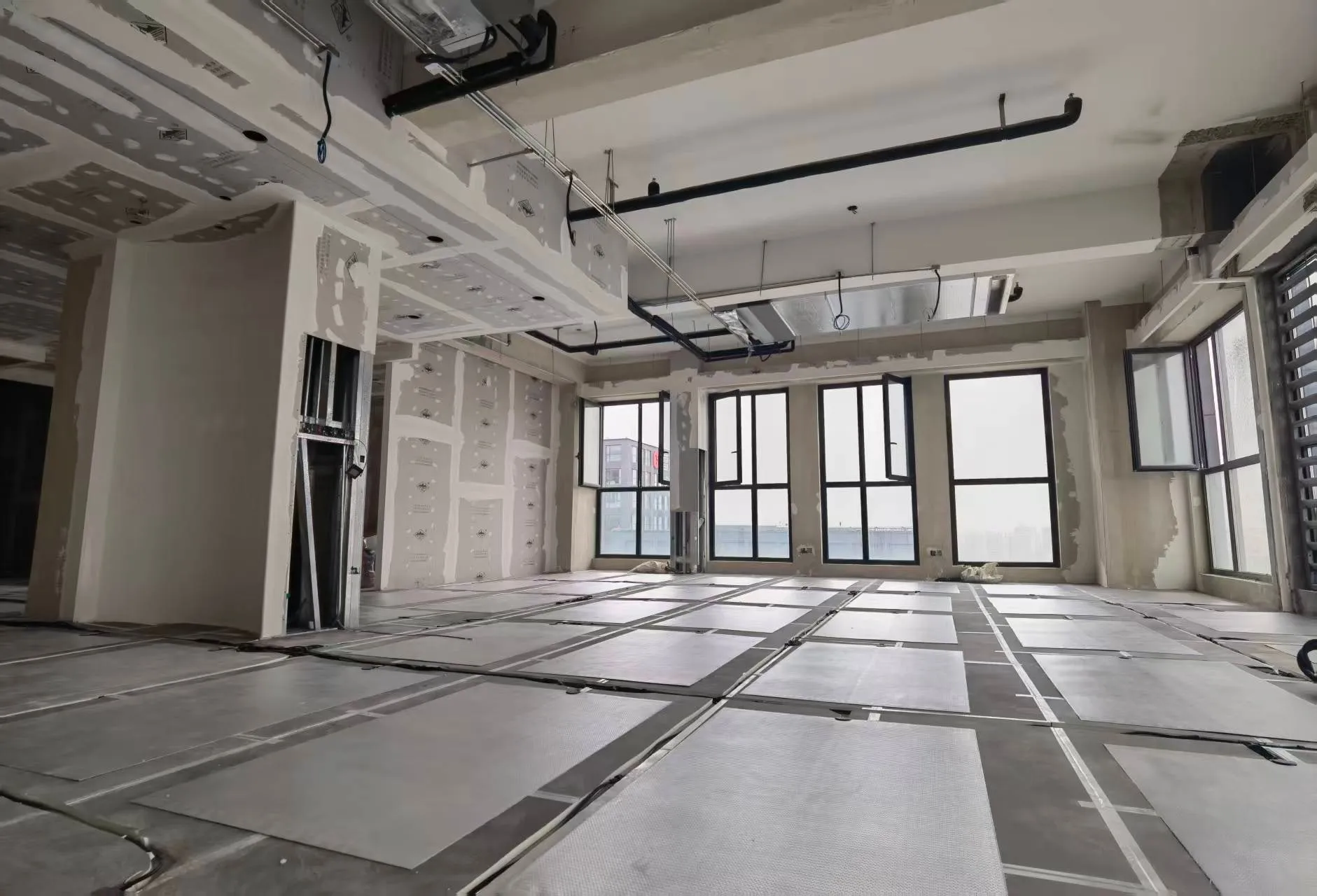 A wide open-plan office with heating installed beneath the floor