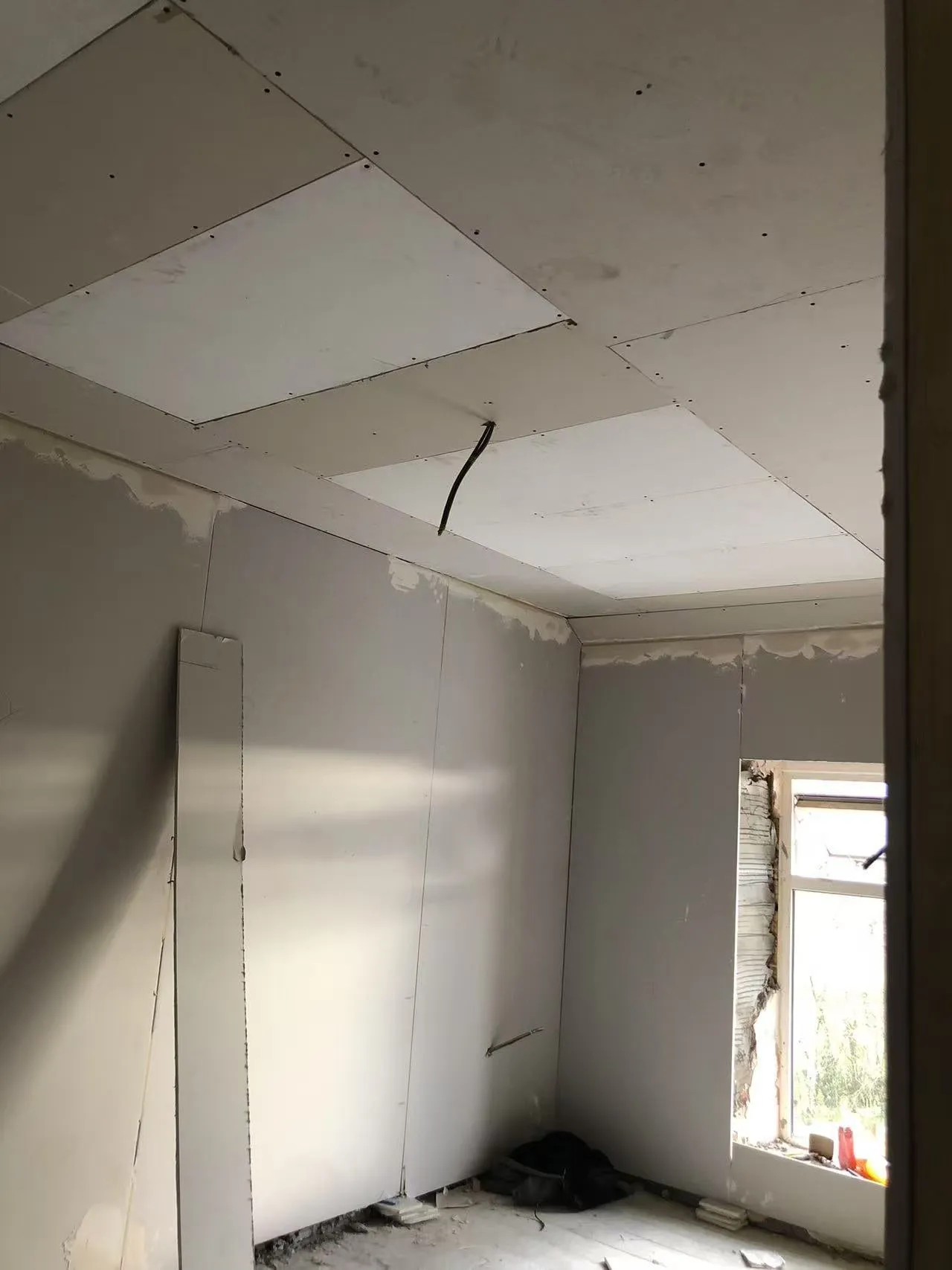 PowerBoard panels fitted flush in a plasterboard ceiling before skimming